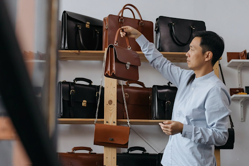 Shopper at Ambur Leather Market holding leather shopping bags