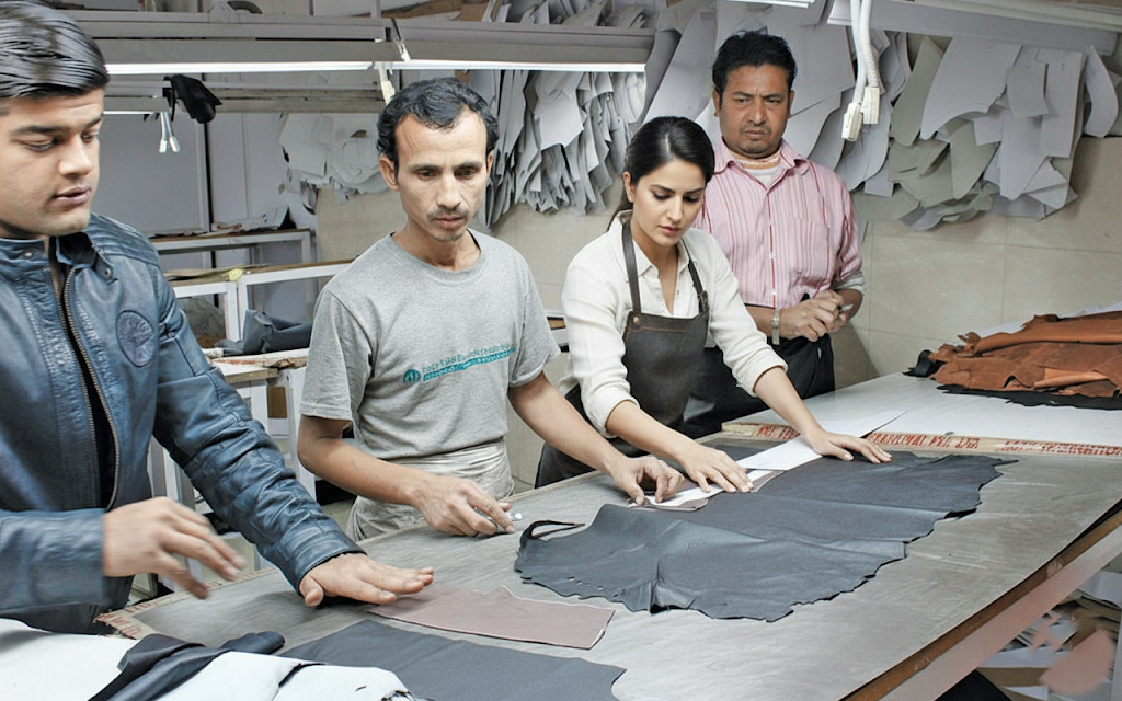 Skilled artisan crafting premium Ambur leather jacket in traditional workshop