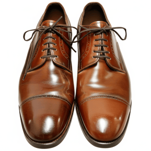 A pair of polished, dark brown leather cap-toe Oxford dress shoes, shown from a top-down angle against a white background.